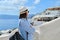 Tourist business, businesswoman posing of landscape of Oia Santorini