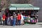 Tourist buying a souvenir gift at a street market stall selling leather handbags and accessories