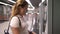 A tourist buys a subway ticket at a metro station in a self-service terminal.