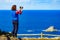 Tourist with camera on Asturias coast, Spain