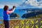 Tourist with camera on Asturias coast, Spain