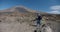 Tourist with camera takes a picture of mountain. Hiker backpacker walks and films amazing view of mount Guajara and