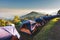 Tourist Camp Tent and Terrace Under Pine Trees Forest During Sunrise, Field Campground for Camping Vacation Adventure Outdoors and