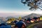 Tourist Camp Tent and Terrace Under Pine Trees Forest During Sunrise, Field Campground for Camping Vacation Adventure Outdoors and