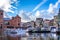 Tourist Canal Boats coming and going from the Damrak Canal in the old city center of Amsterdam