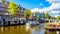 Tourist Canal Boats mooring at Anne Frank House at the Prinsengracht Prince Canal in the Jordaan neighborhood in Amsterdam