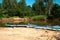 Tourist canoes with paddles stand on the river coast in summer on a water hike. Rafting on inflatable and frame double and triple