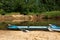 Tourist canoes with paddles stand on the river coast in summer on a water hike. Rafting on inflatable and frame double and triple