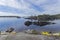 Tourist catamaran and kayaks at the granite shore, Karelia, Russ