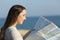 Tourist checking a guide map on the beach