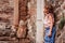 Tourist child girl at stone wall on the walk in Piran, Slovenia