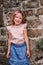 Tourist child girl at stone wall on the walk in Piran, Slovenia