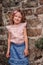 Tourist child girl at stone wall on the walk in Piran, Slovenia