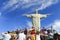 Tourist with Christ the Redeemer on top of Corcovado, Brazil