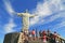 Tourist with Christ the Redeemer on top of Corcovado, Brazil