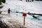 Tourist clearly ignoring the Danger Thin Ice warning sign on Emerald Lake,