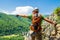 Tourist climber pointing his hand into distance on a via ferrata route in Baia de Fier, Gorj county, Romania.