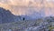 A tourist climber with a small backpack and trekking poles walks in the mountains. Ala-Archa National Park, Kyrgyzstan