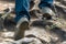 the tourist climbs up the mountain, his legs close-up