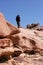 Tourist clumbing on the mountain. Bektau mountains. Rock formations in Bektau Ata in Kazakhstan in summer.