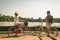 Tourist couple cycling in Angkor temple, Cambodia. Angkor Wat main facade reflected on water pond. Eco friendly tourism traveling