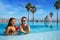 Tourist couple having bath in infinity pool