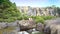 Tourist couple sits on rock watch waterfall