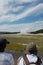 Tourist couple snapping photo at Old Faithful in Yellowstone National Park