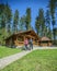 Tourist couple strolling around a glamping site with a log cabin the background