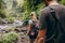 Tourist couple walking by stream