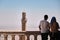Tourist couple watching ancient mardin and grand mosque minaret background