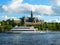 Tourist cruise boat floats on the blue water of the lake on the background of the beautiful buildings of Stockholm