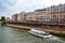 Tourist cruise boat on Seine river waterfront, Paris