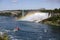 Tourist cruise Ship boat under Rainbow on The Niagara River visiting the Water Falls on a sunny Summer Day