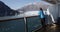 Tourist on cruise ship travel in Alaska looking at glacier from balcony