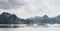 Tourist cruise ships sailing among limestone mountains in Halong Bay, Vietnam