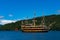 Tourist cruiser and vermilion Tori gate on Ashi lake, Hakone