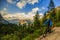 Tourist cycling in Cortina d`Ampezzo, stunning rocky mountains o