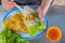 Tourist eating Vietnamese cuisine- Banh Xeo crepe with fresh vegetables