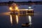 Tourist enjoy boat ride at Gadisar lake at night with ancient architecture at Jaisalmer, Rajasthan, India