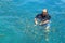 Tourist enjoy with feeding fish in a tropical sea at Phi Phi isl