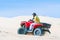 Tourist enjoy riding the quad bike or powerful fast off-road four-wheel drive ATVs at white sand dunes