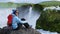 Tourist enjoying the beautiful view of Godafoss waterfall