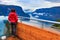 Tourist enjoying fjord view on Stegastein viewpoint Norway