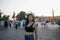 Tourist enjoying the main Jemaa el Fna square of Marrakech next to the Moroccan flag