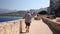 Tourist enjoying the stunning view of the beach and mountains in Calvi, Corsica, Europe