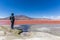 Tourist enjoying the surreal view of Laguna Colorado in Bolivia