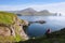 Tourist enjoying the view of the Faroe Islands on Vagar Island