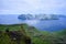 Tourist enjoying the view of Vagar Island from Mount Sornfelli in Faroe Islands