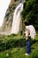 Tourist enjoying waterfall